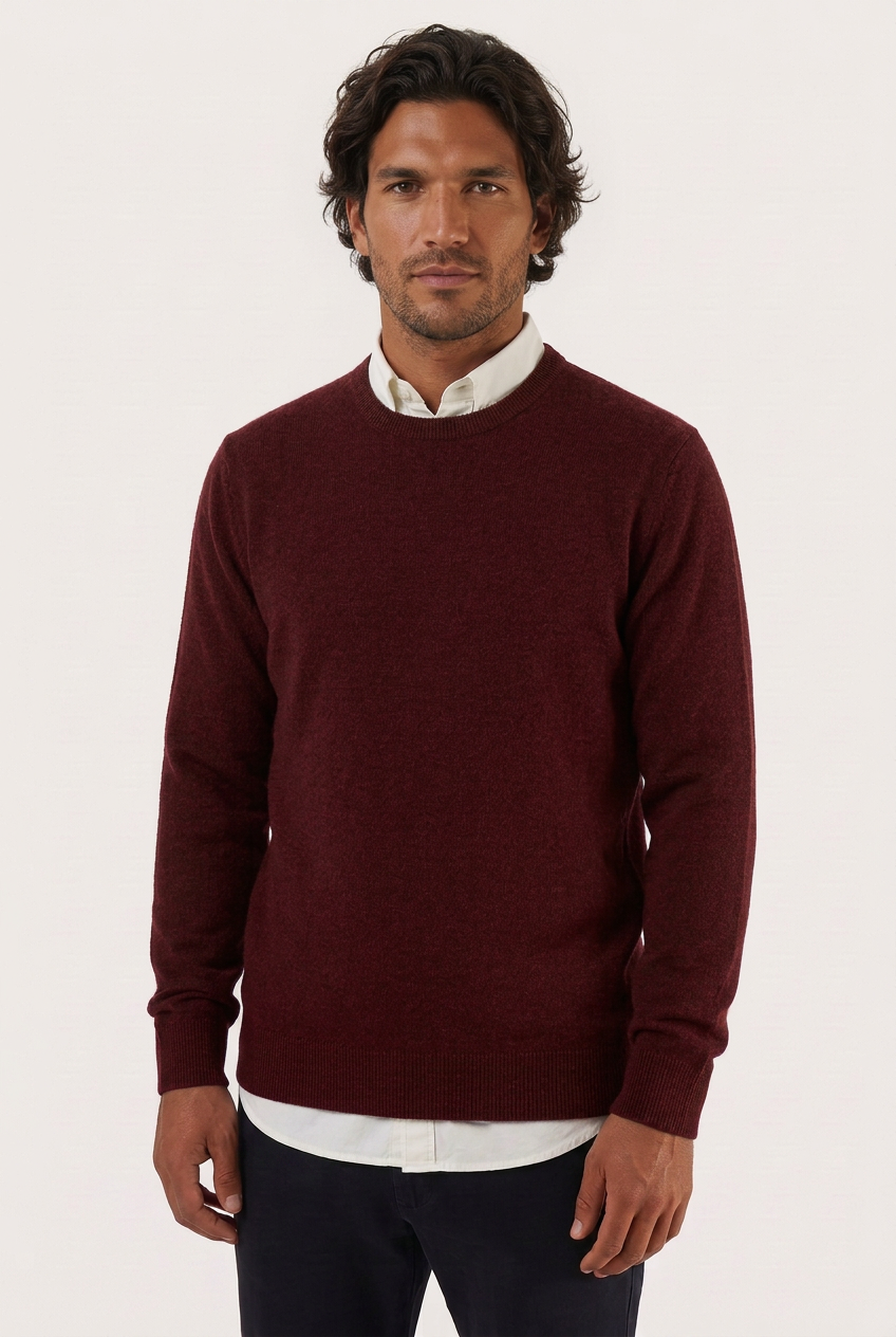 Camisola de lã e caxemira bordeaux com decote redondo, modelo moreno com camisa branca